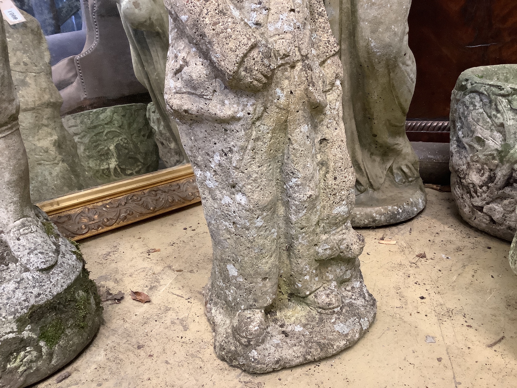 A reconstituted stone garden ornament of a standing figure, height 57cm